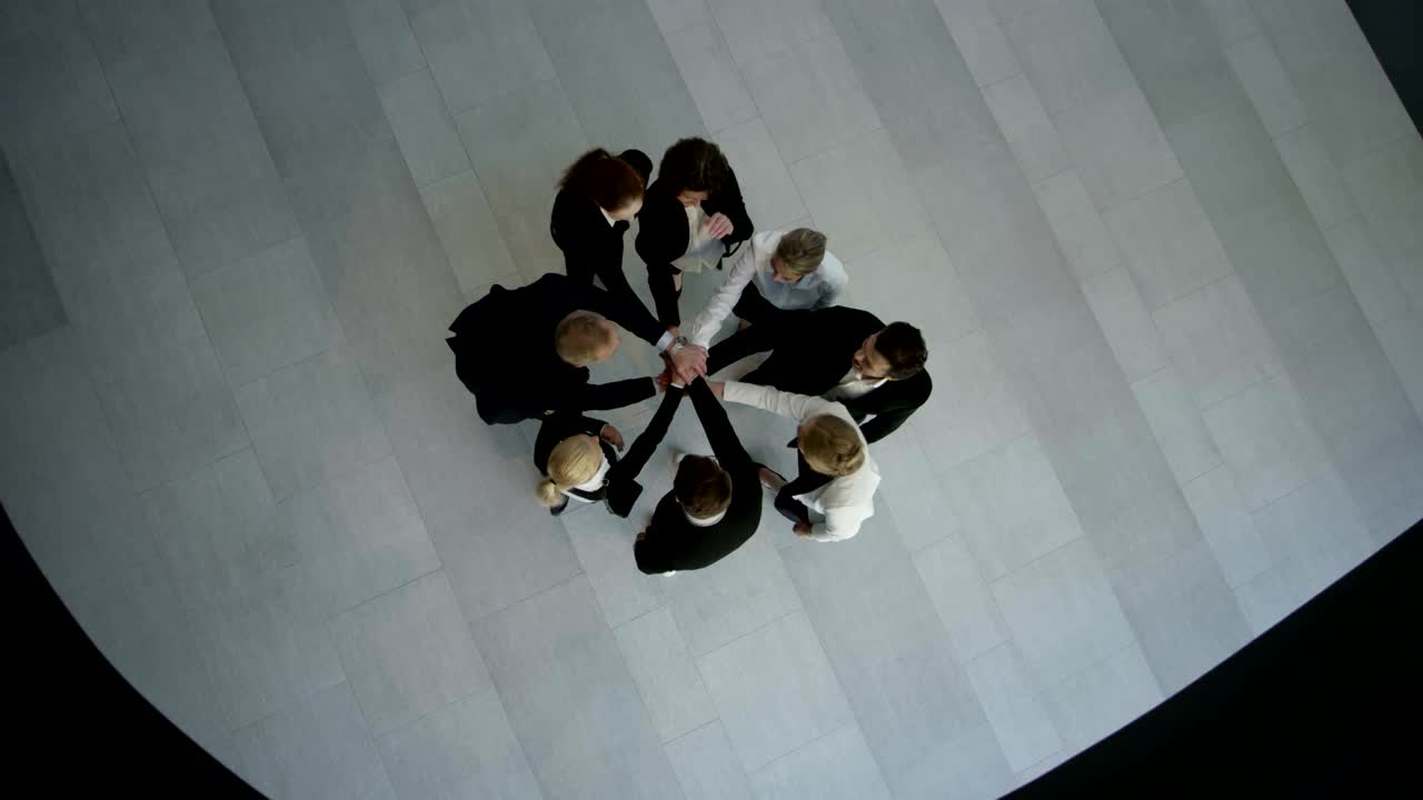 Business people stacking hands