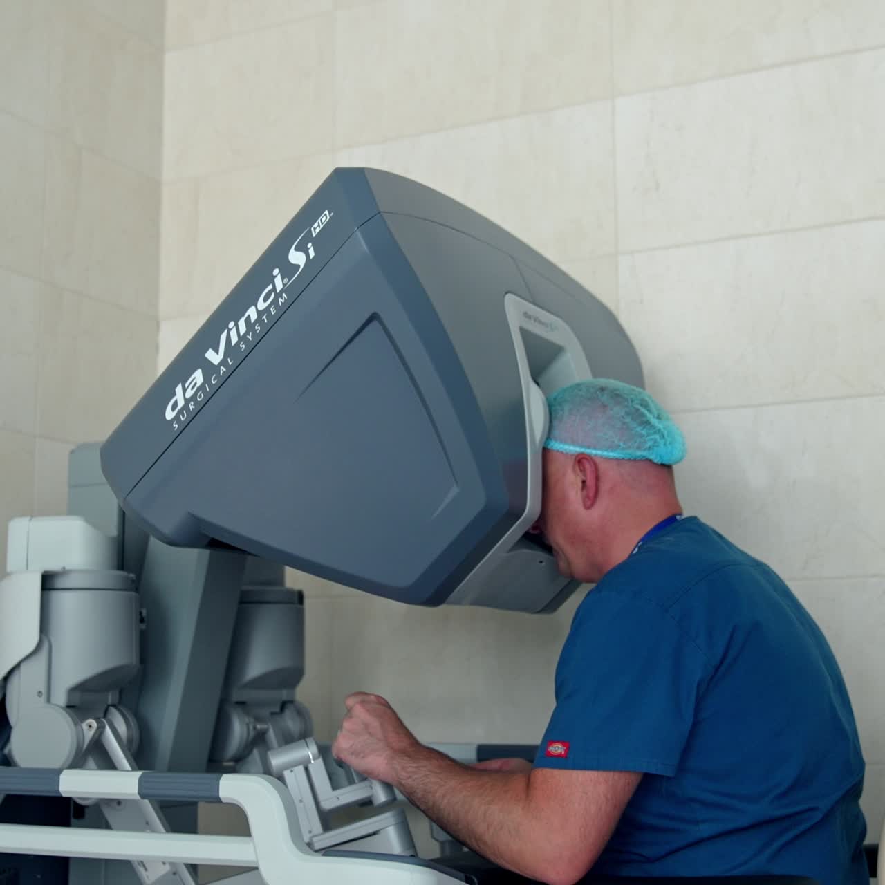 Specialist sitting at apparatus for controlling work of robotic equipment. Da Vinci system in modern clinics close up