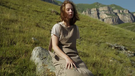 woman sitting in mountains