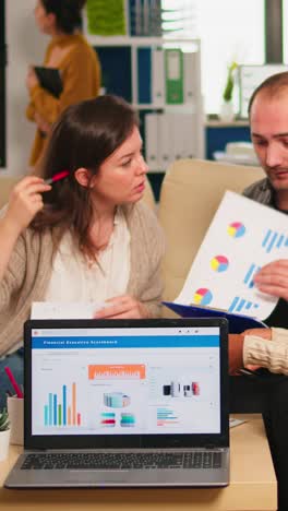 vertical video diverse colleagues employees cooperating in office discussing at workplace
