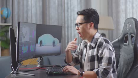 man yawning while working on 3d car design in home office