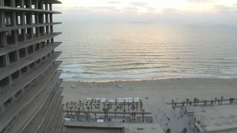 Drone-shot-of-a-building-next-to-the-ocean