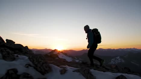 a solitary hiker ascends a mountain trail at sunrise, silhouetted against the vibrant colors of dawn, embodying the spirit of adventure and exploration in the great outdoors.