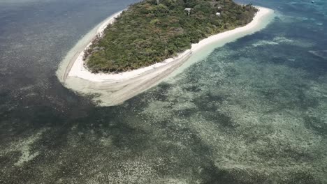 Drone-aerial-of-green-tropical-island-by-a-clear-blue-water-reef