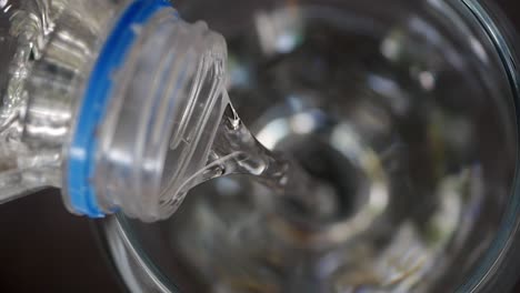 water pouring from bottle into glass