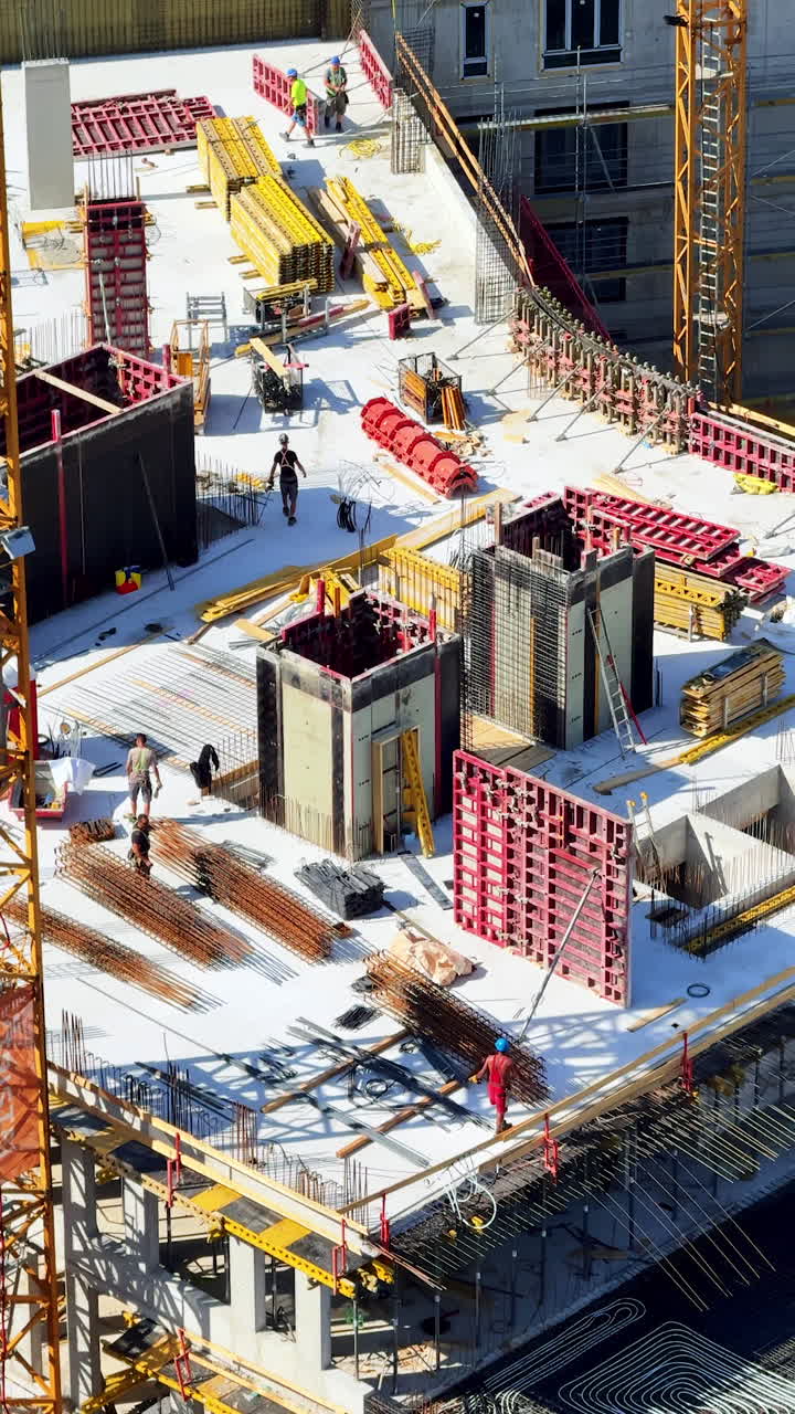 Sunny day at construction site. Workers are busy at a construction site, laying foundations and assembling structures under clear blue skies