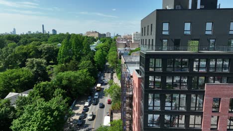 aerial truck shot of modern apartment building revealing prospect park in brooklyn, new york