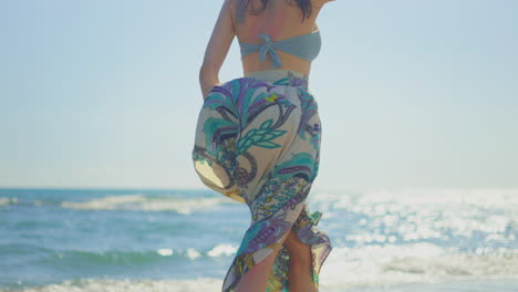 woman on the beach in a floral skirt