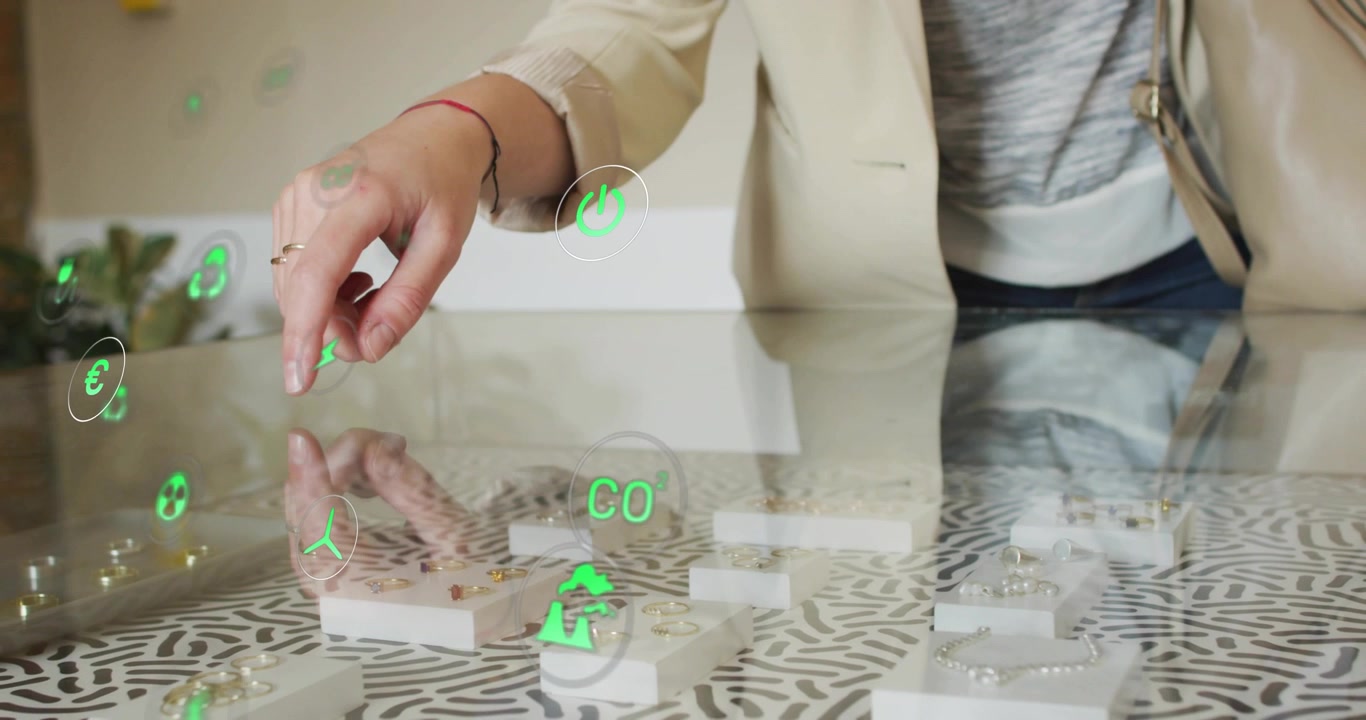 Woman shopper tapping recycling icon on jewelry then toggling wind water CO? and solar metrics