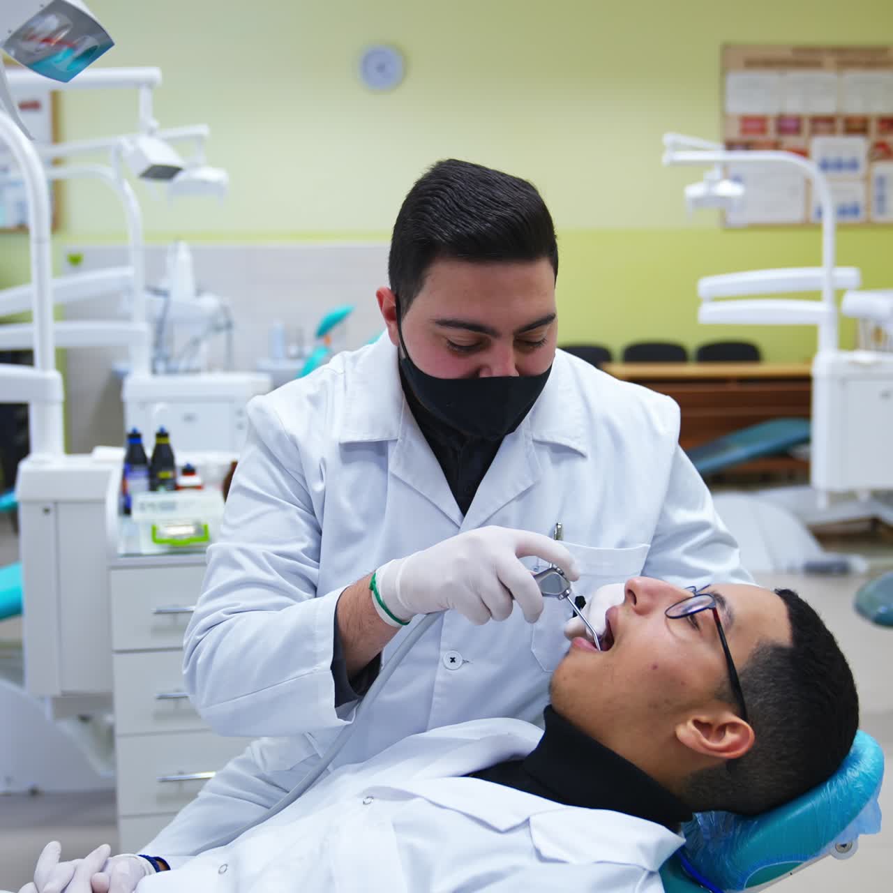 Clinical dental student demonstration. Young stomatology specialist learning work with teeth