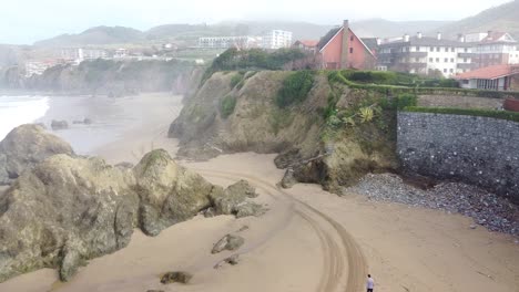 Aerial-drone-view-of-the-beach-of-Bakio-in-the-Basque-Country-in-a-foggy-day