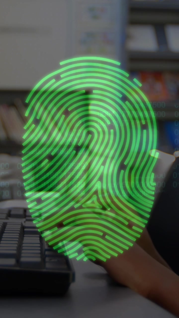 Bio metric fingerprint scanner against boy using computer