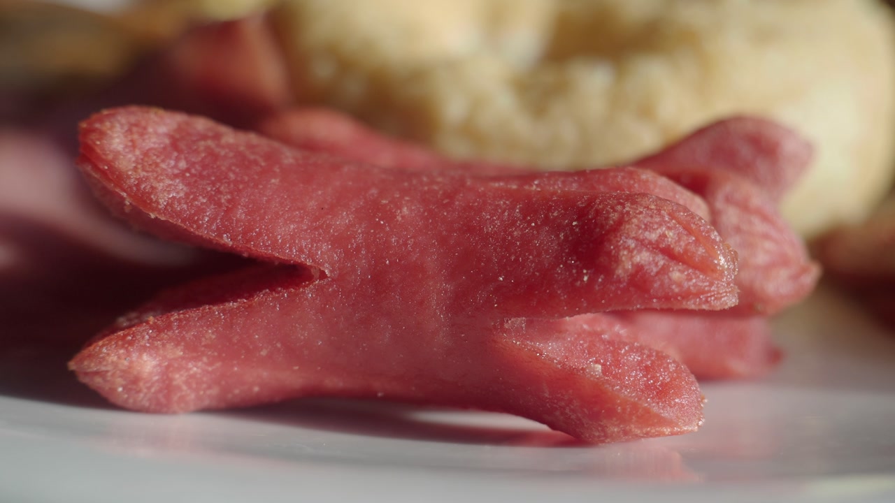 Close-up of Fried Sausages on a White Plate
