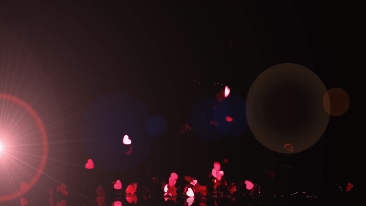 Bright pink lens flare radiating left while heart confetti, bokeh orbs floating above shiny floor