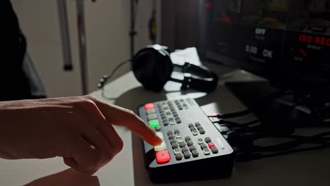 hand operating a video switcher during live production