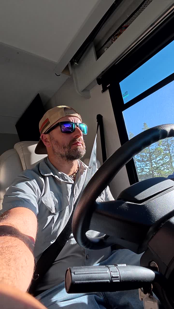 Man Driving a Recreational Vehicle on a Sunny Day