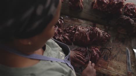 african woman cutting the meat