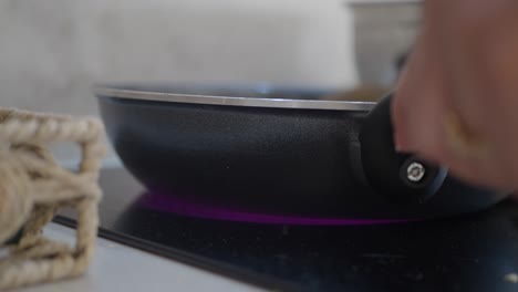 a black frying pan on an induction hob