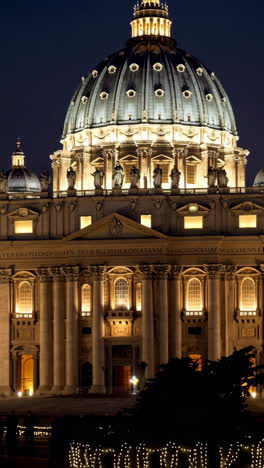 st. peter's basilica and gardens at night, illuminated with christmas lights