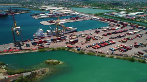 Shipping-container-port,-boat-docked-by-cranes,-Curacao-Caribbean