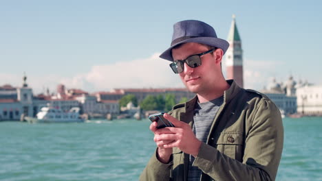 man using a smartphone in venice