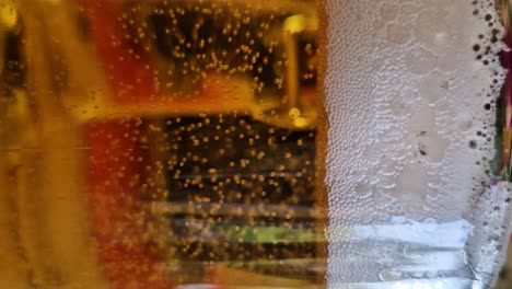 tasty draft beer in glass, close up vertical view