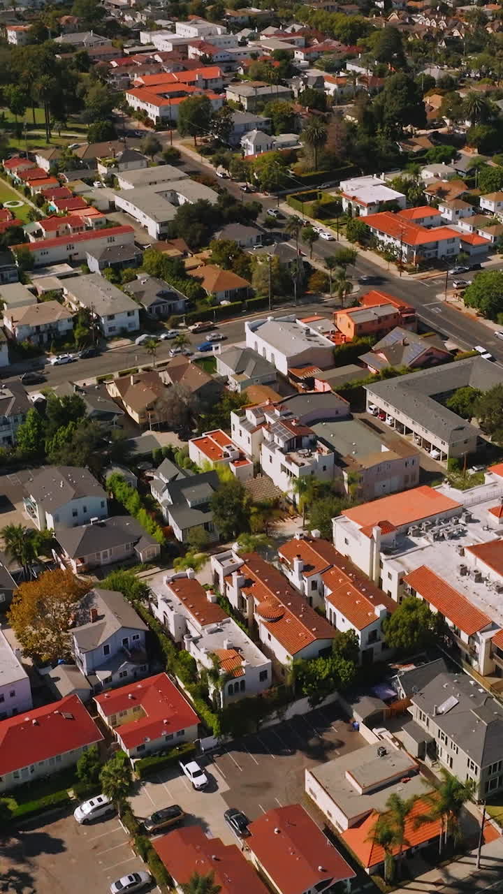 Lovely sight of Santa Barbara houses with similar orange roofs. Beautiful streets of sunny city from aerial perspective. Vertical video