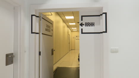 open door to a modern office corridor