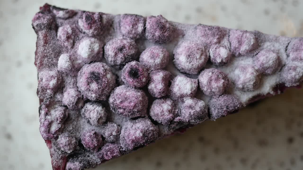 Close-up of a Frozen Blueberry Dessert Slice with Powdered Sugar