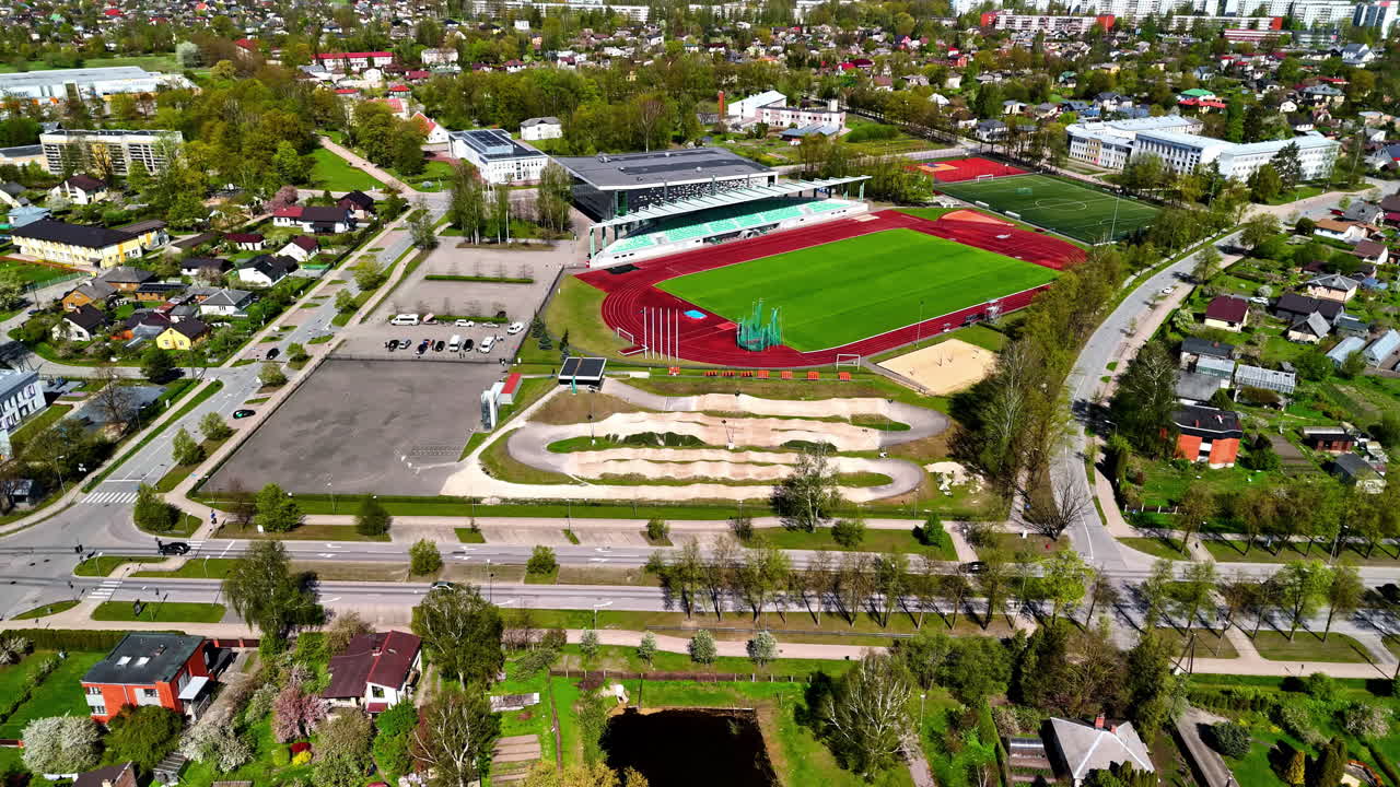 Captivating aerial view of Jelgava showcasing the harmonious integration of sports facilities, residential communities, and urban infrastructure