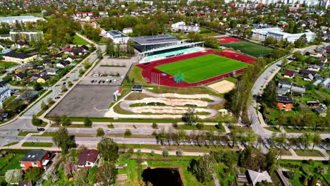 captivating aerial view of jelgava showcasing the harmonious integration of sports facilities, residential communities, and urban infrastructure
