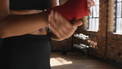 Boxing-athlete-hands-in-red-bandage-for-workout