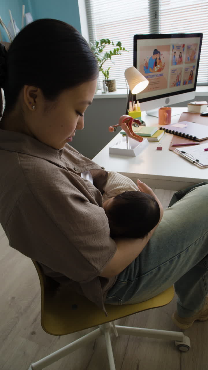 Mother breastfeeding baby in doctor's office