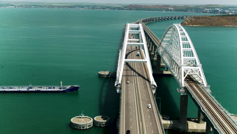 aerial view of a modern arch bridge over a waterway