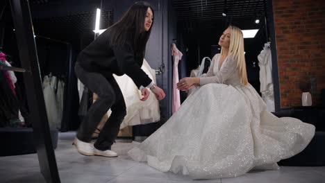 elegant bride being fitted for wedding dress