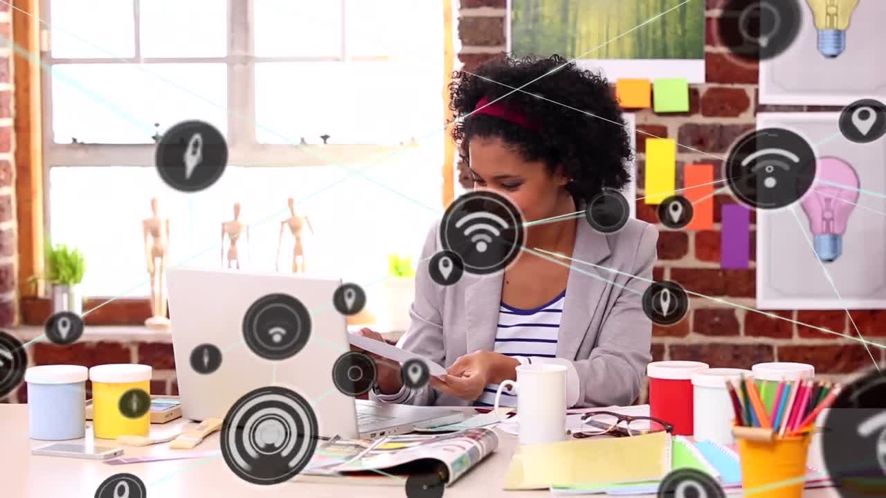 Animation of network of digital icons against portrait of happy african american woman smiling