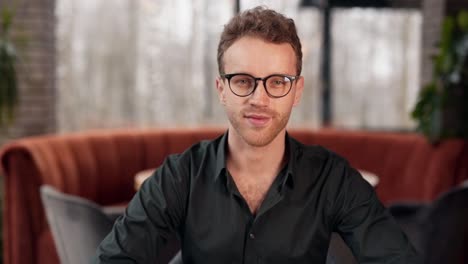 Close-up-portrait-of-a-young-curly-handsome-man-smiling