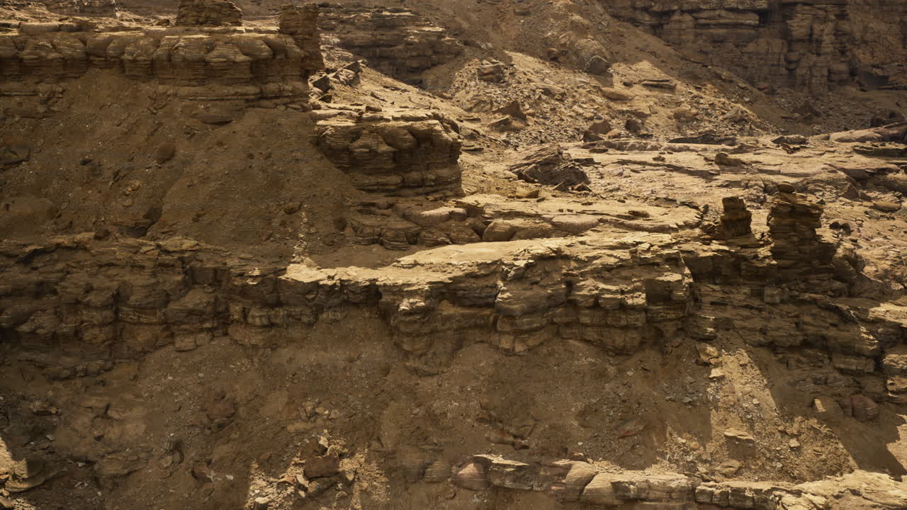 Rocky terrain with layered formations and rugged landscape in arid region