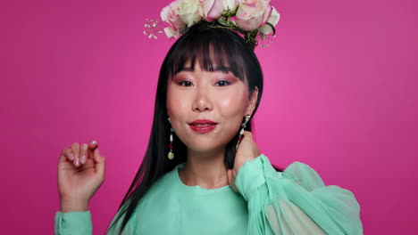 woman in a floral headpiece and mint green dress