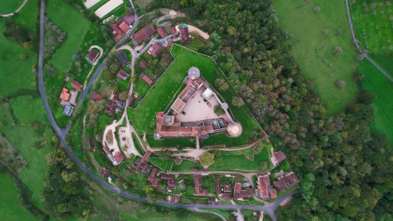 Aerial view of Castelnau-Bretenoux Castle in lush greenery