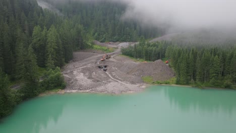 Drohnenaufnahmen-Zeigen-Die-Gewaltige-Ausdehnung-Einer-Schlammlawine-In-Den-Alpen,-Während-Maschinen-Und-Arbeiter-Fleißig-Versuchen,-Das-Gelände-Wiederherzustellen