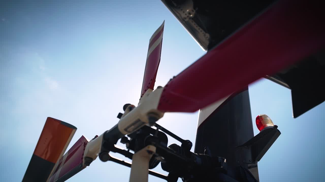 Helicopter tail rotor orbit with sun flare in slow motion