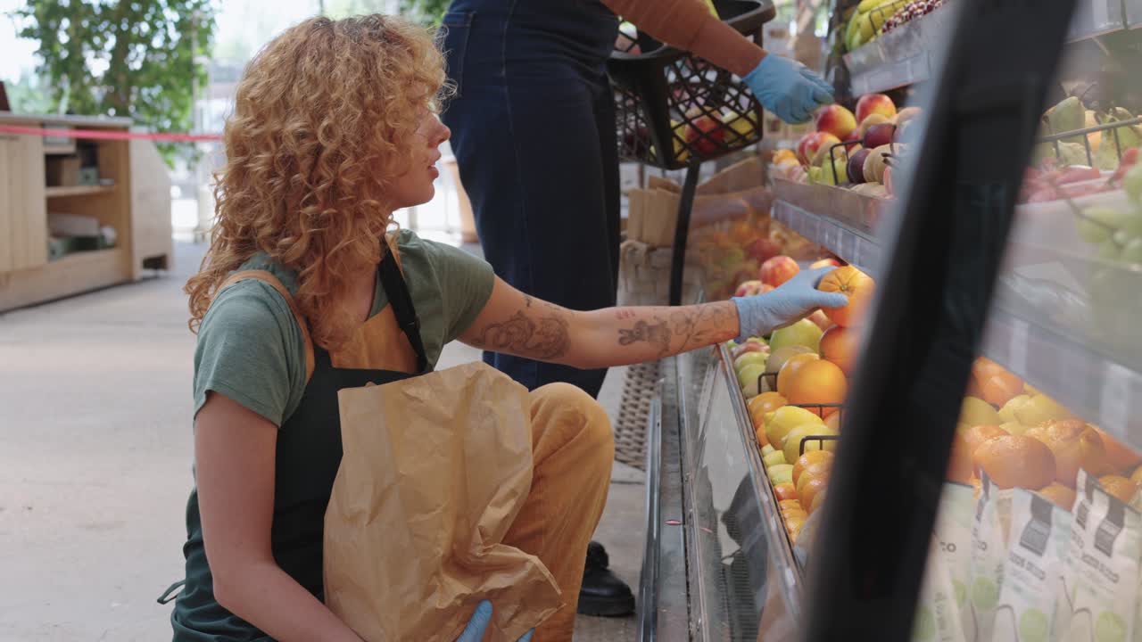 Woman shopping for fruit at grocery store