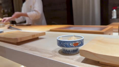 chef skillfully prepares sushi in a restaurant