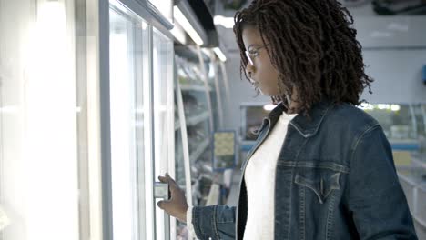 Thoughtful-African-American-woman-shopping-at-grocery-store