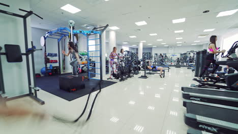 girls training in fitness gym. view of sports gym with training people