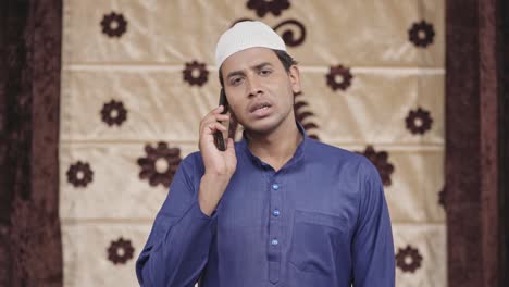 indian muslim man talking on a call to someone