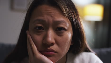 close up of stressed or anxious woman suffering with depression anxiety or loneliness sitting in room at home 3