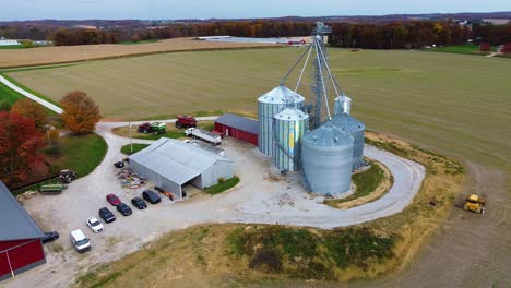 midwest farm with grain silos and barns, aerial drone