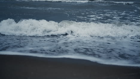 waves foam splash beach in sea background landscape. blue ocean water surface.